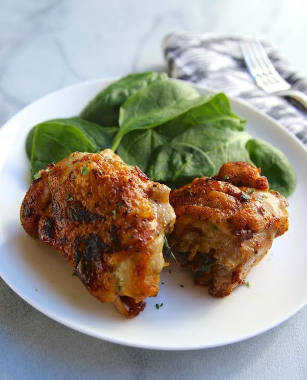 Recipe for crispy chicken thighs stuffed with fresh spinach, creamy gruyere, and salty proscuitto.