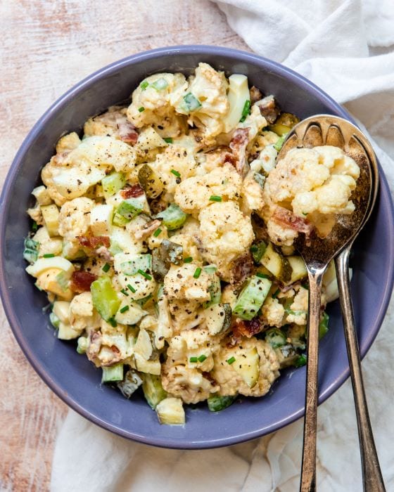 Recipe for keto potato salad, made with traditional ingredients and cauliflower instead of potatoes.